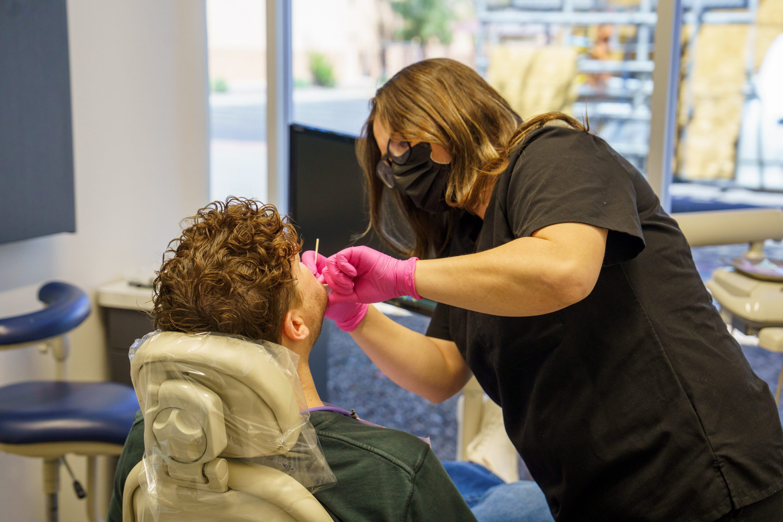 A dental staff performing a check up